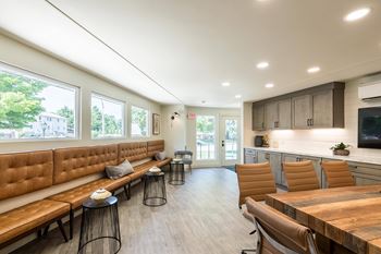 A modern kitchen with a wooden table and chairs.at 3TEN, Illinois
